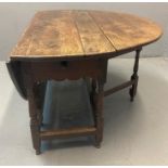 17th century oak gate leg table, the hinged and folded top above a single drawer with knob handle,