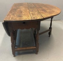 17th century oak gate leg table, the hinged and folded top above a single drawer with knob handle,