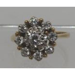 Diamond cluster ring set in 18ct gold. The brilliant cut diamonds set in an open cluster.