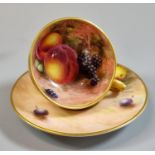 Royal Worcester porcelain demi-tasse hand painted with fruit, the cup with gilt exterior, signed