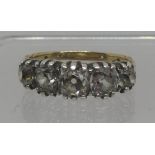Diamond five stone ring set in white metal with yellow metal band. Of three old cushion cut and