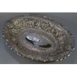 Impressive Indian silver bowl, of oval form ornately embossed and decorated with flowerheads, scroll