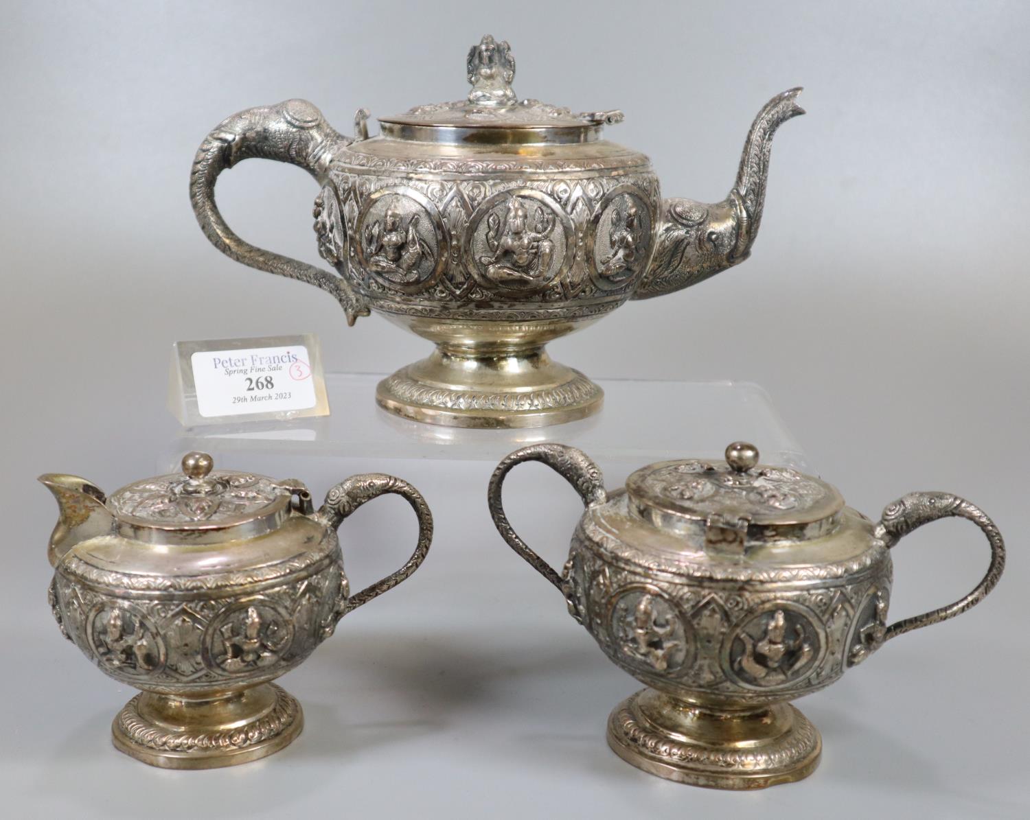 Indian white metal three piece teaset comprising: teapot, two handled lidded sucrier and a lidded