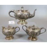 Indian white metal three piece teaset comprising: teapot, two handled lidded sucrier and a lidded