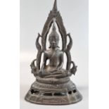 Thai cast yellow metal patinated figure of a seated Shakyamuni Buddha, framed in flaming mandala.