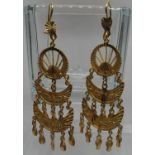 A pair of Indian pendant earrings. Yellow metal tests as 18ct gold. Approx weight 13.4 grams. (B.