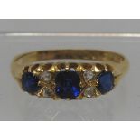 Sapphire and diamond ring set in 18ct gold. The three sapphires separated by rose cut diamonds. Ring