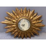 Early 20th century Smiths eight day gilded sunburst clock with Arabic face. With key. Overall 67cm