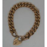 9ct gold curb link bracelet with engraved links and heart shaped clasp. Approx weight 28.2 grams. (