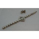 Opal bracelet and earrings , the bracelet set with nine opals in a diamond shape with a graduated