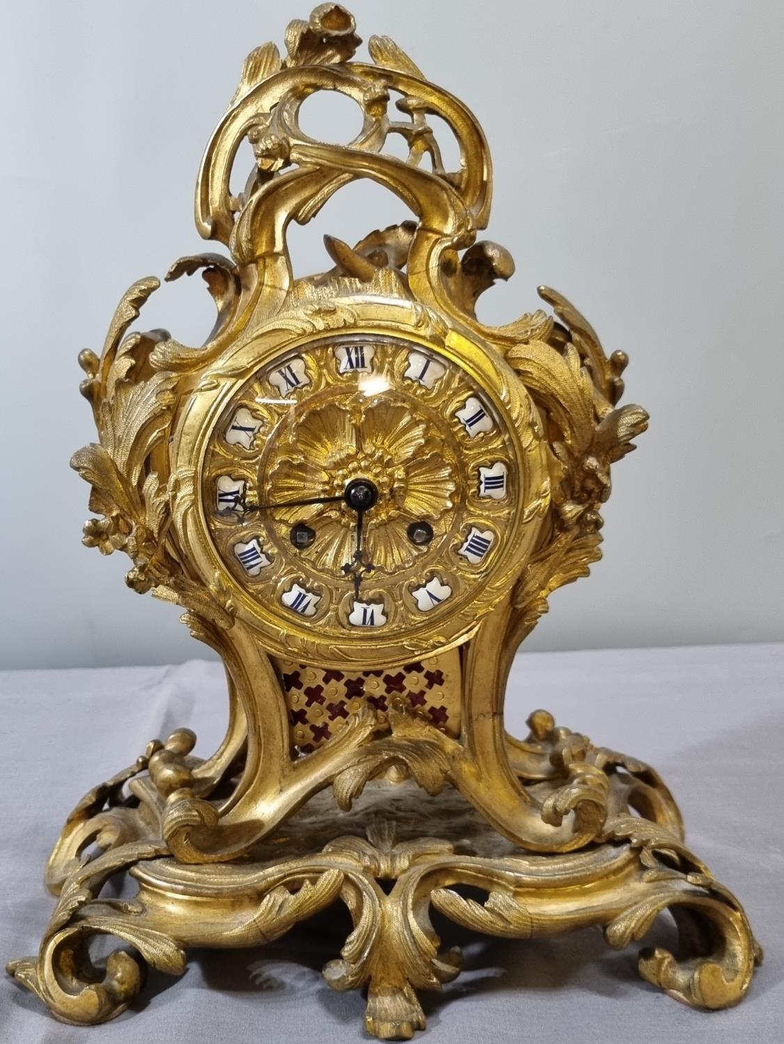 Late 19th century French ormolu rococo style balloon shaped mantle clock, overall decorated with