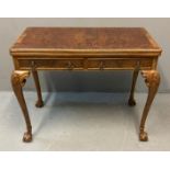 Georgian style walnut fold over card table, the moulded top with hinged lid and green baize above