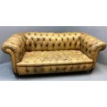 Late 19th/early 20th century tan leather button back Chesterfield style sofa, having scroll arms