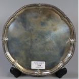 Late Victorian silver pie crust salver with gadrooned edge standing on four shell feet by '