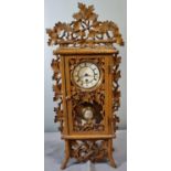 German Black Forest design foliate decorated mantle clock, having white Roman face and exposed