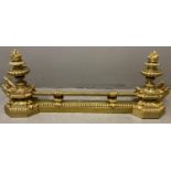 19th century rococo style yellow metal fire fender with two urn shaped capitals, flambe mount and