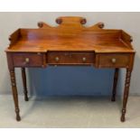 19th century mahogany ladies dressing table, the shaped gallery top with moulded roundels above a