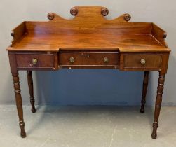 19th century mahogany ladies dressing table, the shaped gallery top with moulded roundels above a