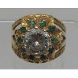 18ct gold flower ring set with a large white stone surrounded by emeralds. Ring size O. Approx