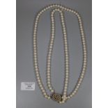 A double row cultured pearl necklace with 9ct gold pearl set clasp. Length 25 inches. (B.P. 21% +