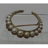 Pearl set crescent brooch of twenty one graduated pearls set in 9ct gold. Diameter approx 30mm.