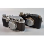 Two Leica viewfinder roll film cameras, both with F50mm Leitz Elmar standard lenses, one having