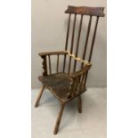 Primitive design stick back armchair on moulded saddle seat, carved 'Gelli'. 111cm high approx. (B.
