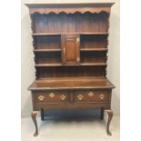 18th century style oak two stage dresser, the moulded cornice above a shaped frieze, boarded rack