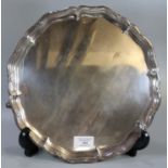 George V silver pie crust salver raised on three scroll feet, by 'Hawksworth, Eyre Co. Ltd.'