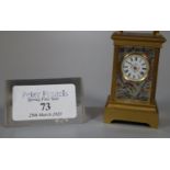 Miniature gilt brass carriage clock with silvered and enamelled face and side panels decorated
