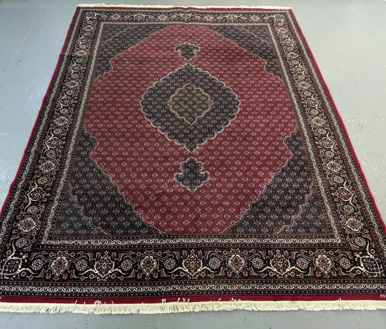 Rich red ground full pile Iranian carpet of Persian Kashan design. (B.P. 21% + VAT)