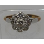 Diamond daisy cluster ring set in 18ct gold and platinum. Ring size R&1/2. Approx weight 3.4