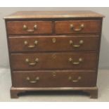 Late 18th century oak straight front chest of drawers, the moulded top above a bank of two short and