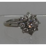 Diamond cluster ring set in 18ct white gold. The central brilliant cut diamond an estimated 0.