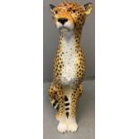 Modern ceramic handpainted study of a cheetah with naturalistic features, in seated pose. Probably