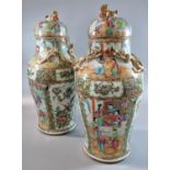 Pair of Canton famille rose baluster vases and covers, decorated all over with panels of figures