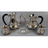 Indian white metal four piece tea service comprising teapot and water jug with ebonised handles,