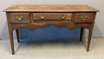 18th century oak dresser base, the moulded top above an arrangement of three drawers with brass swan