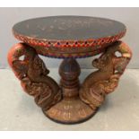 Unusual Thai hardwood stained and lacquered temple table, of circular form, the base decorated