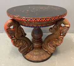 Unusual Thai hardwood stained and lacquered temple table, of circular form, the base decorated