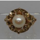 Cultured pearl ring in decorative yellow metal setting. Ring size L. Approx weight 6.3 grams. (B.