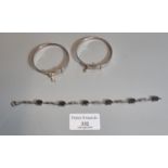 Two silver christening bangles and a silver bracelet set with smokey quartz stones. (B.P. 21% + VAT)