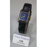 Cartier gold plated on silver rectangular faced ladies wristwatch with blue dial and cabochon