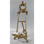 Early 20th century Rococo style brass table easel with pierced C scroll decoration. 42cm high