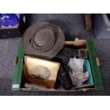 Box of assorted items to include: leather gun holster and ammo belt, two clear glass oil lamp