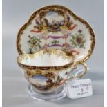 Continental porcelain, hand painted and gilded tea cup and saucer with vignettes of nautical/