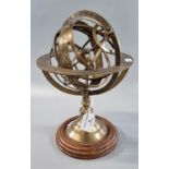 Reproduction brass Armillary Sphere globe on pedestal base with wooden plinth. 28cm high approx.