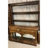 19th century Welsh oak dresser, the moulded cornice above open rack, the projecting base above two