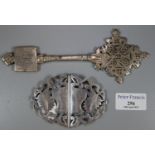 White metal belt buckle decorated with foliage together with a white metal cross Touareg. (B.P.