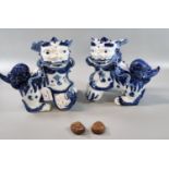 Mirror matched pair of blue and white 20th century modern Fo Dogs, the female with a pup beneath her